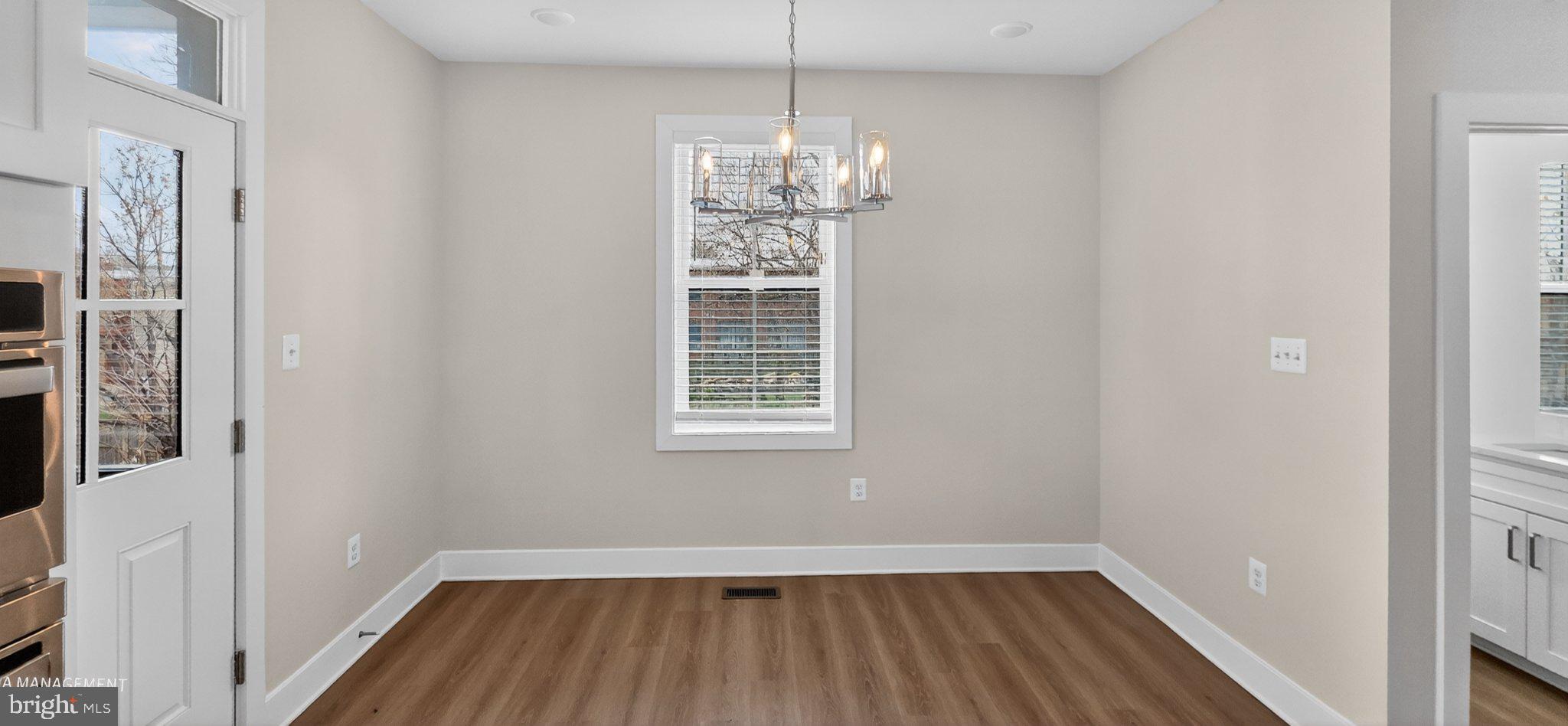 426 Chapel Alley, Unit 8 Frederick, MD 21701 - Photo 11 of 34 a view of a room with wooden floor and windows