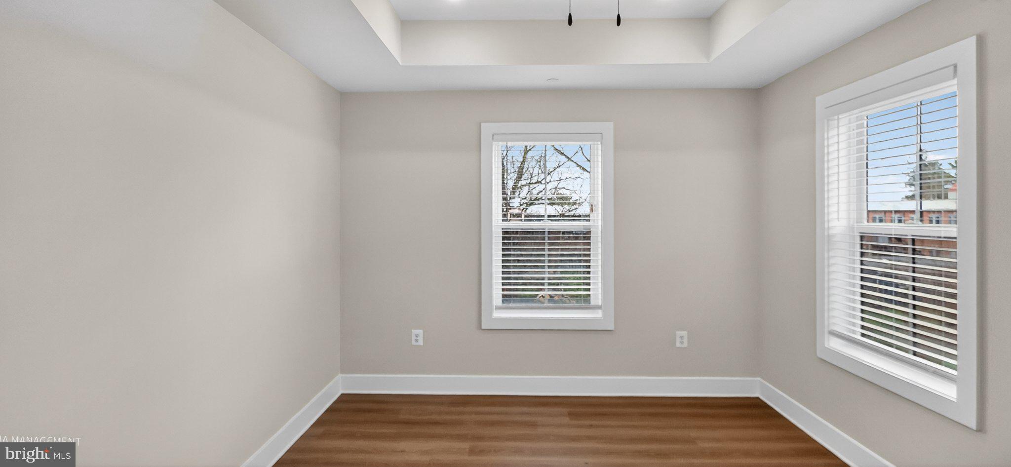426 Chapel Alley, Unit 8 Frederick, MD 21701 - Photo 22 of 34 a view of an empty room with wooden floor and a window