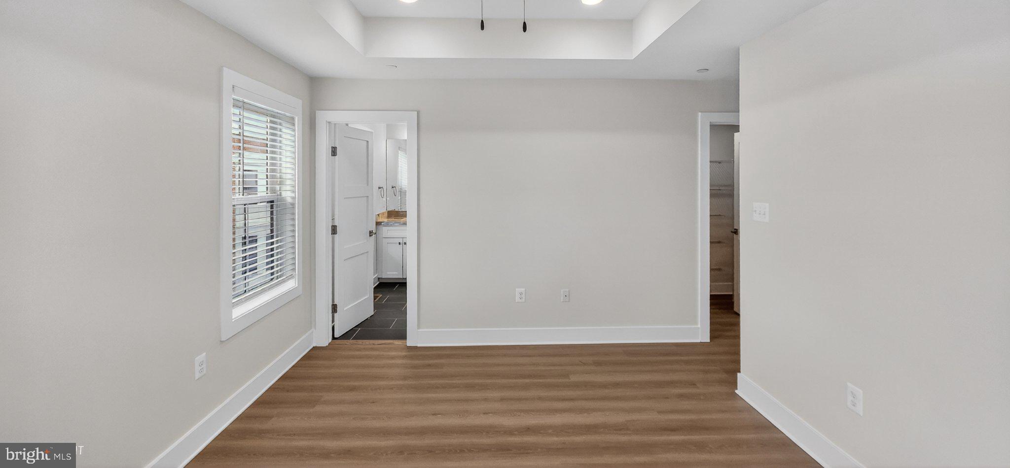 426 Chapel Alley, Unit 8 Frederick, MD 21701 - Photo 23 of 34 a view of a hallway with wooden floor and windows