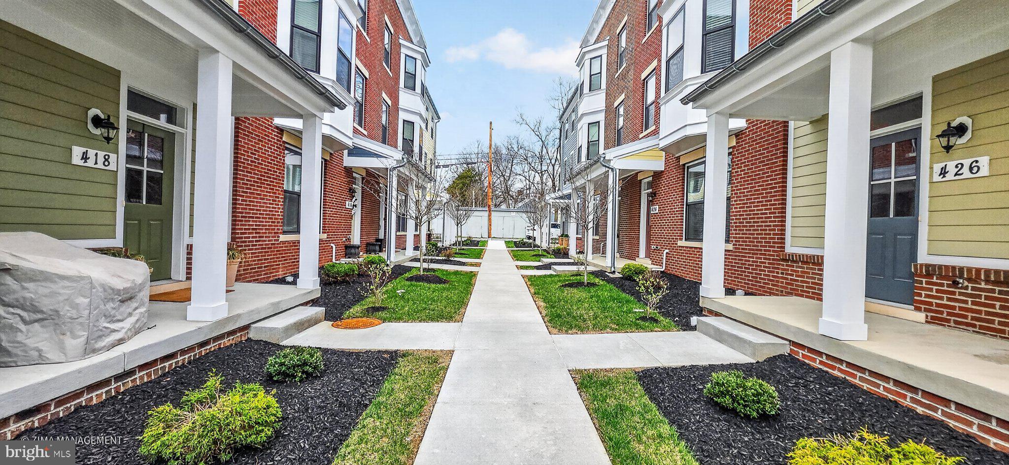 426 Chapel Alley, Unit 8 Frederick, MD 21701 - Photo 3 of 34 a view of buildings with pathway and yard