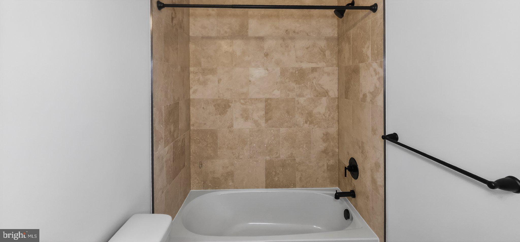 426 Chapel Alley, Unit 8 Frederick, MD 21701 - Photo 33 of 34 a bathroom with a bathtub and shower