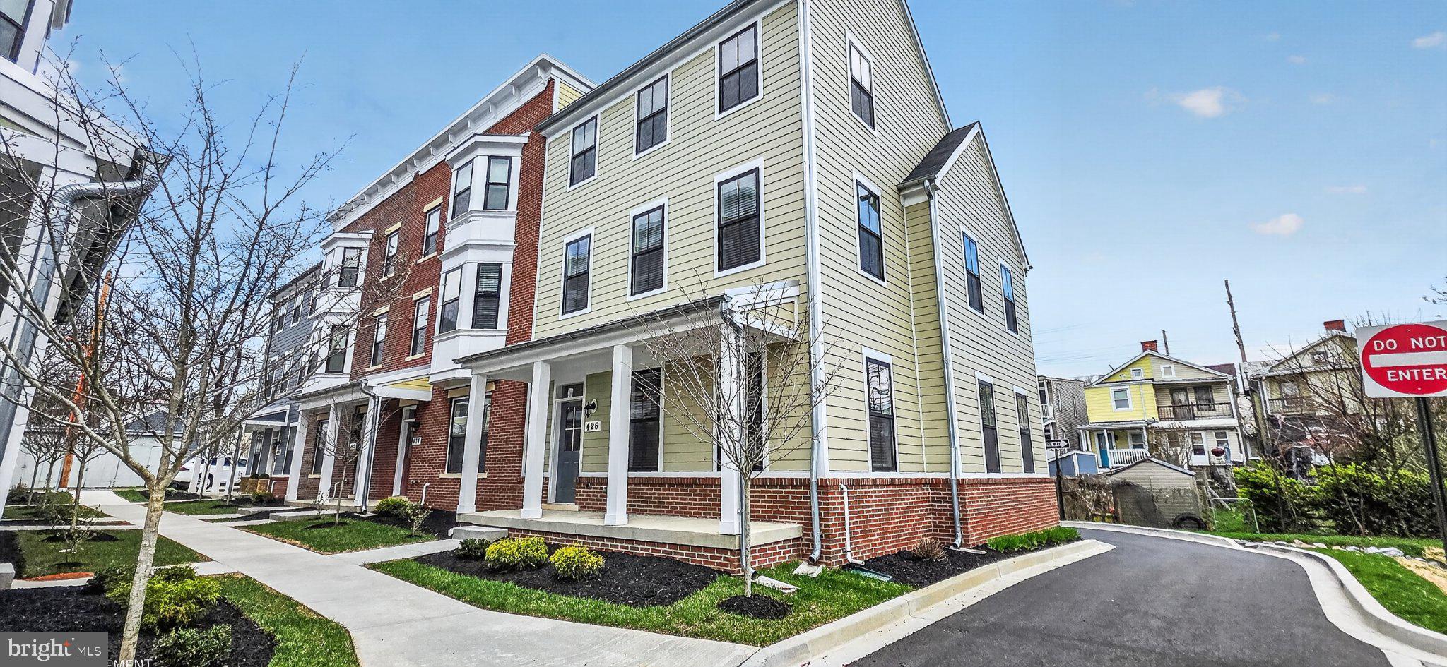 426 Chapel Alley, Unit 8 Frederick, MD 21701 - Photo 4 of 34 a front view of a building with a garden and plants