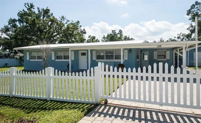 a view of a house with a wooden bench