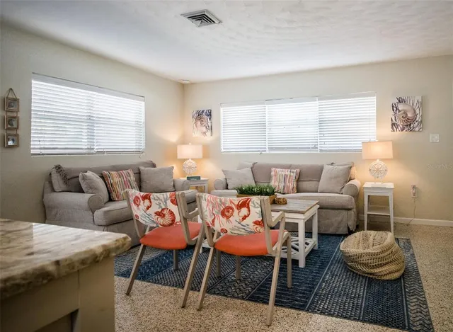 a living room with furniture a rug and a window