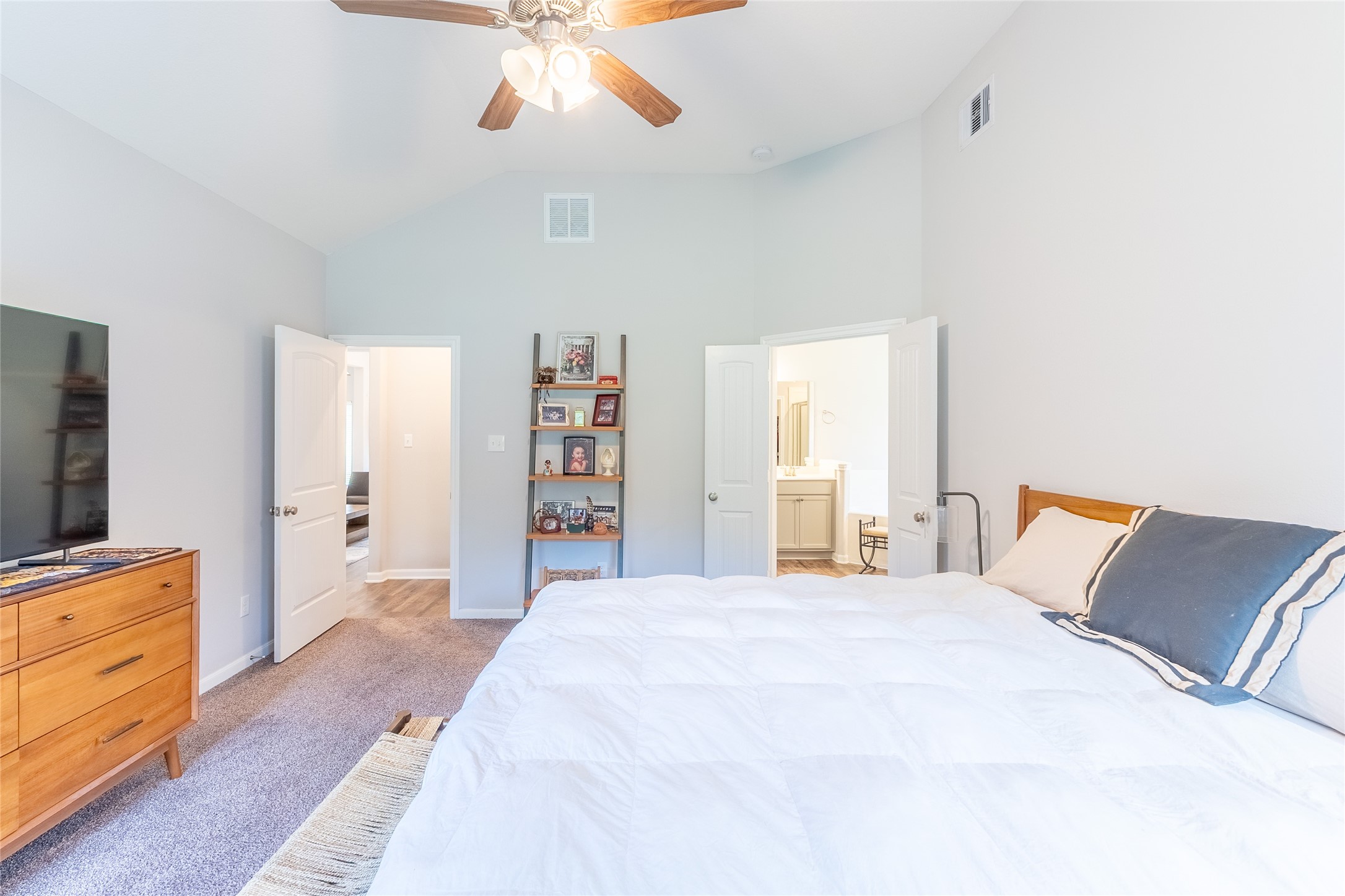 120 Sanctuary Road Huntsville, TX 77340 - Photo 23 of 38 a bedroom with a large bed and a flat tv screen on dresser