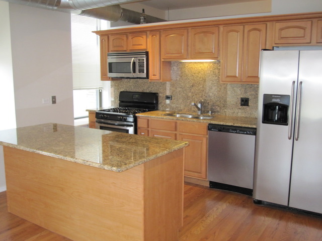 811 South Lytle Street, Unit 212 Chicago, IL 60607 - Photo 5 of 14 a kitchen with stainless steel appliances granite countertop a sink a stove and a refrigerator