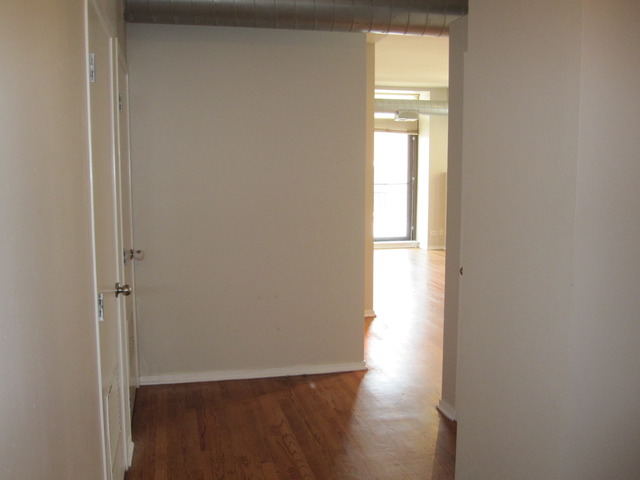 811 South Lytle Street, Unit 212 Chicago, IL 60607 - Photo 7 of 14 a view of empty room with wooden floor and fan