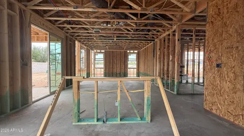 a view of a room with wooden floor and windows