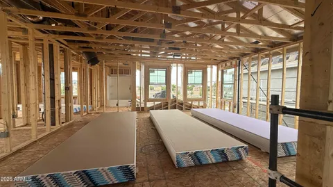 a spacious bedroom with a large window and furniture