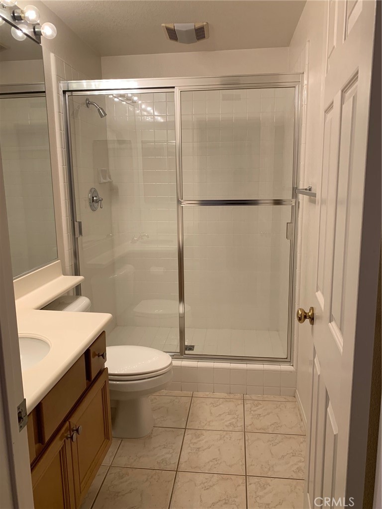 1 Pompeii Irvine, CA 92606 - Photo 7 of 10 a bathroom with a granite countertop sink toilet and shower