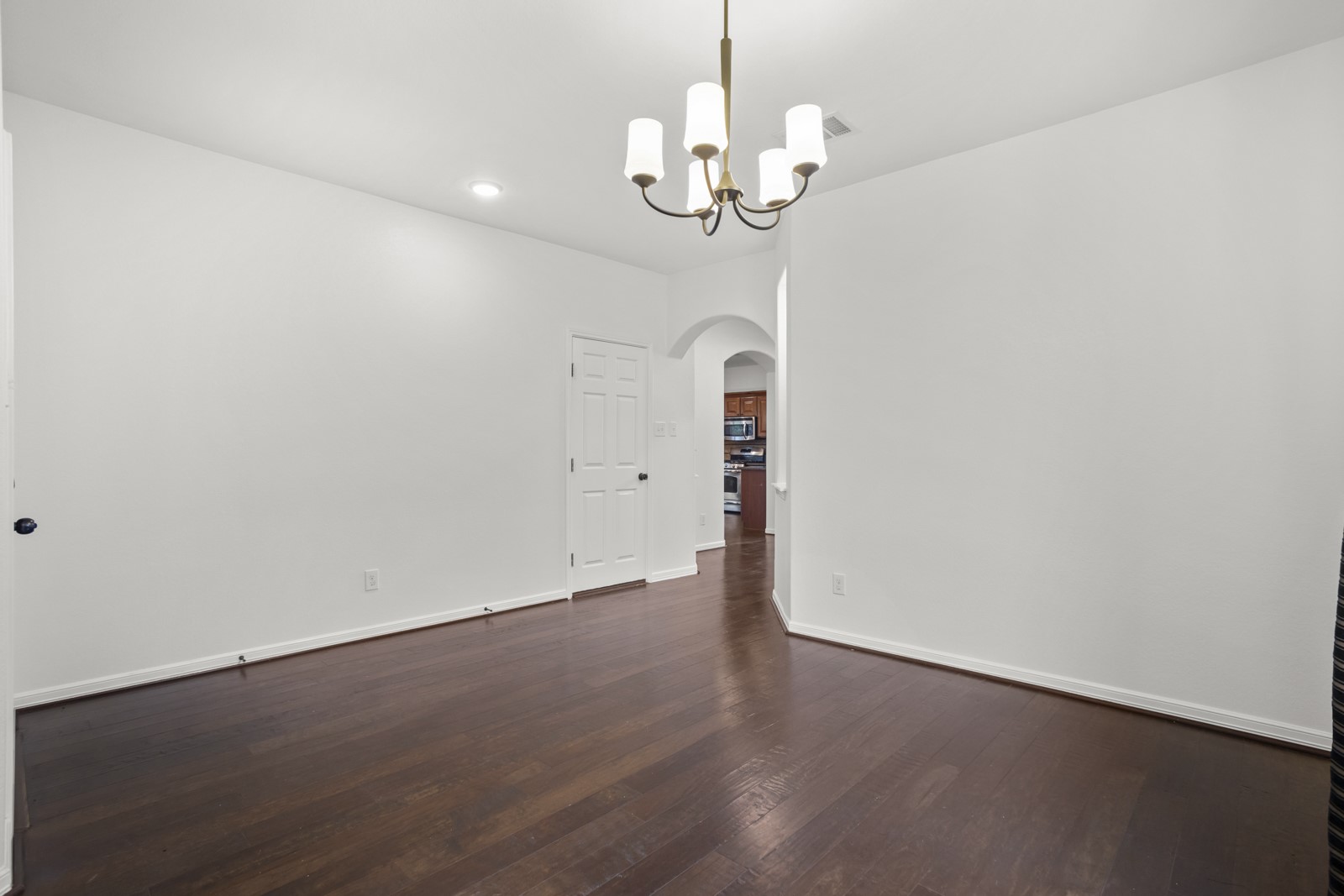 245 Razzmatazz Trail Buda, TX 78610 - Photo 5 of 37 Dining space featuring dark wood-finish flooring, a five-light chandelier, recessed lighting, and white baseboards