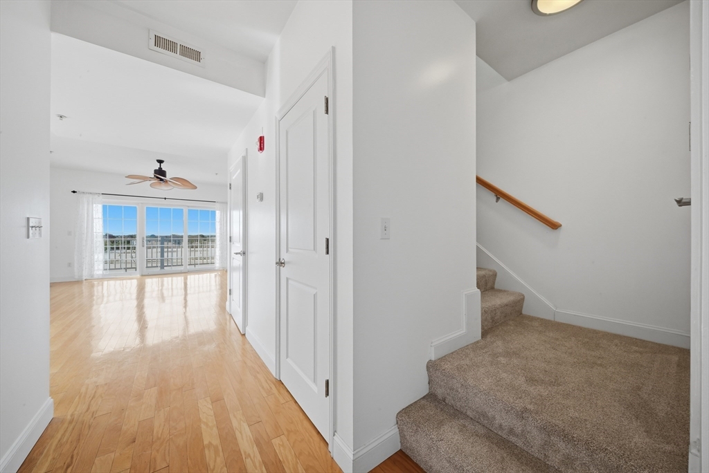 233 Beach Road, Unit A11 Salisbury, MA 01952 - Photo 8 of 37 a view of a hallway view with wooden floor and staircase