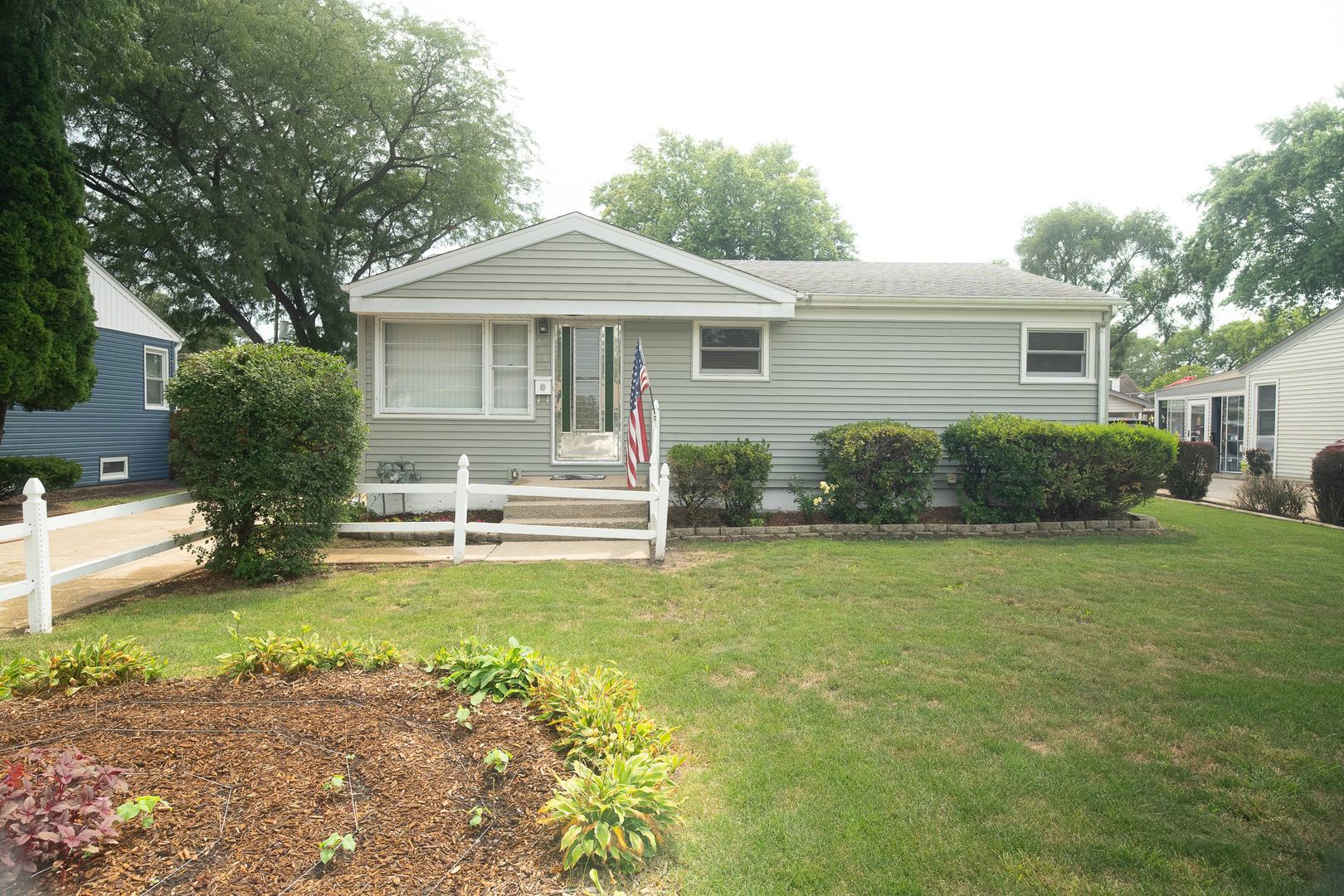 a front view of a house with a garden