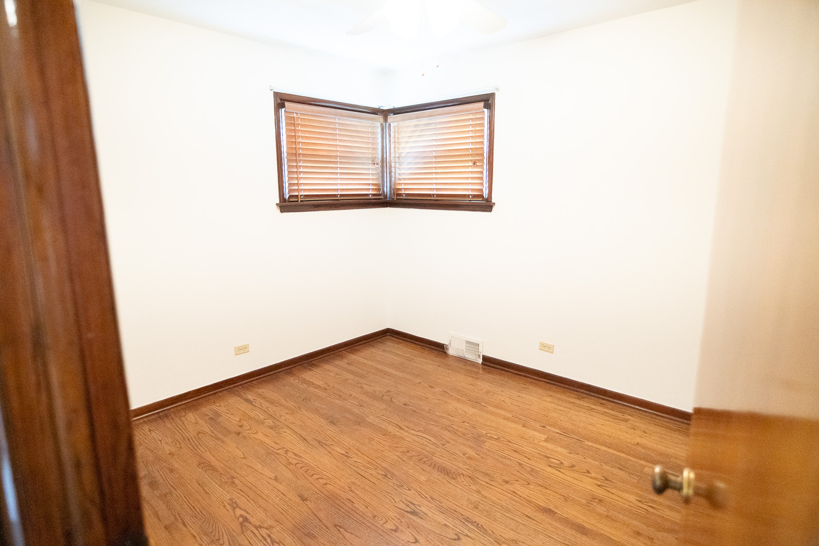 6645 Riverside Drive Tinley Park, IL 60477 - Photo 12 of 38 an empty room with wooden floor and windows