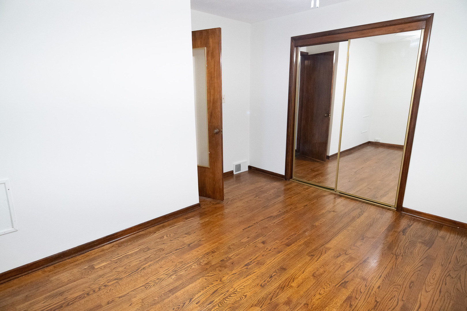6645 Riverside Drive Tinley Park, IL 60477 - Photo 17 of 38 wooden floor in a hall with an empty room