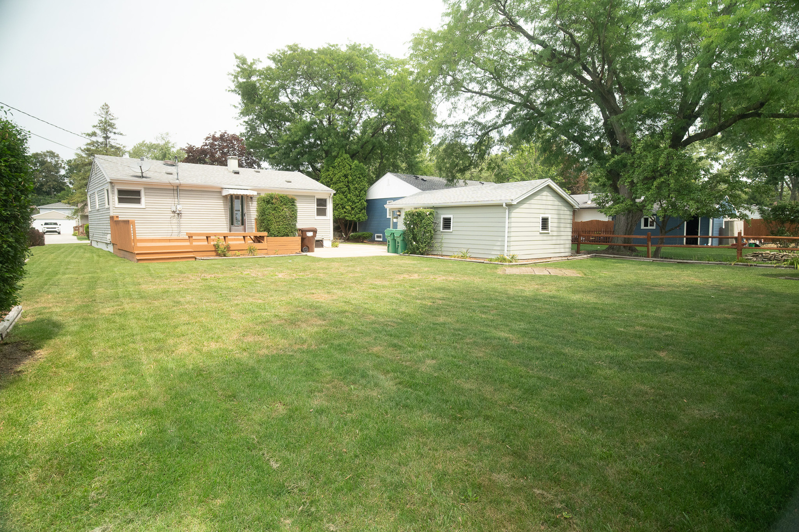 6645 Riverside Drive Tinley Park, IL 60477 - Photo 29 of 38 a front view of a house with a garden and trees