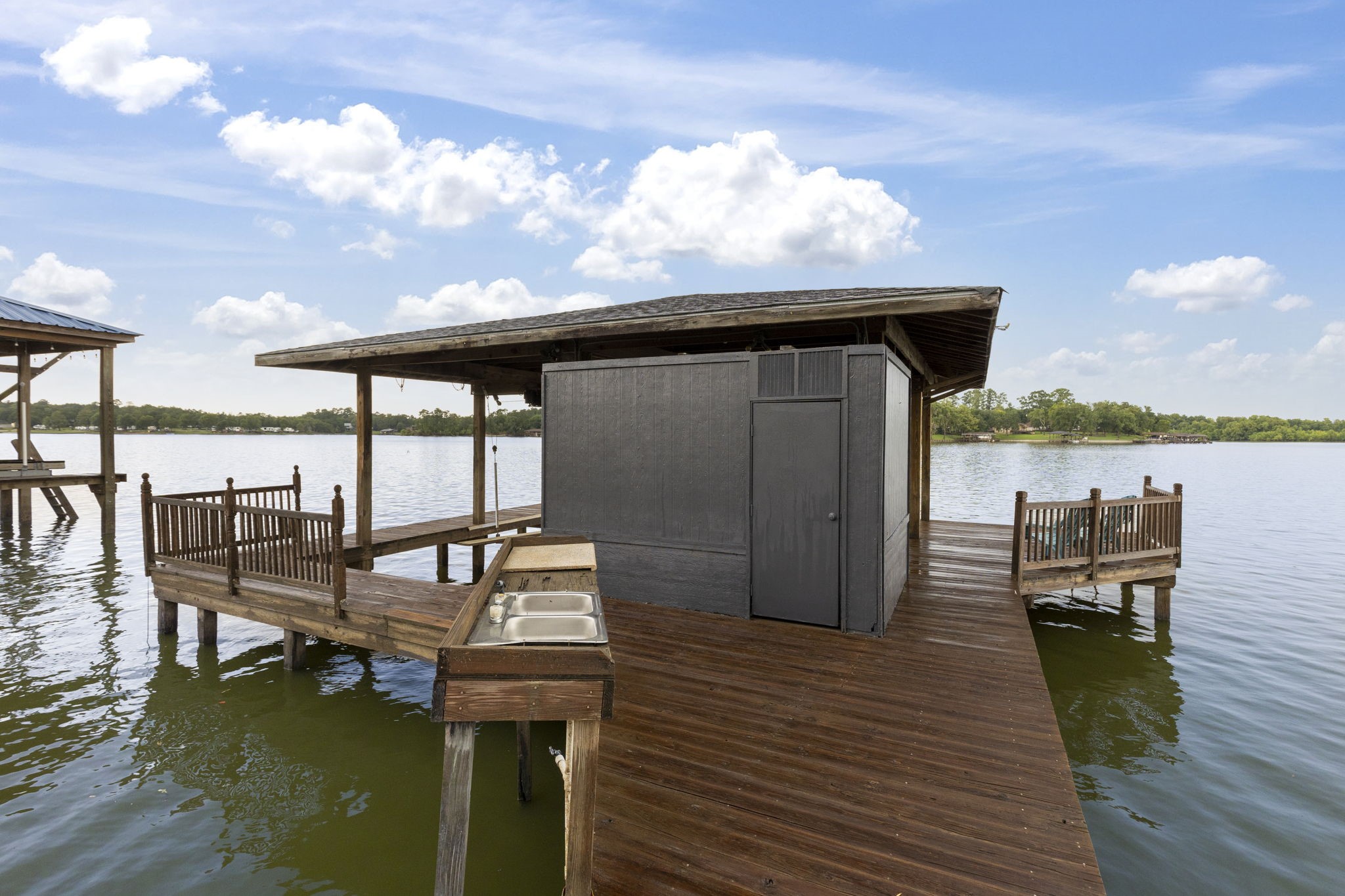 245 Lakeland Road Huntsville, TX 77320 - Photo 46 of 49 Boat house is equipped with two slips, ample storage and a convenient fish cleaning station