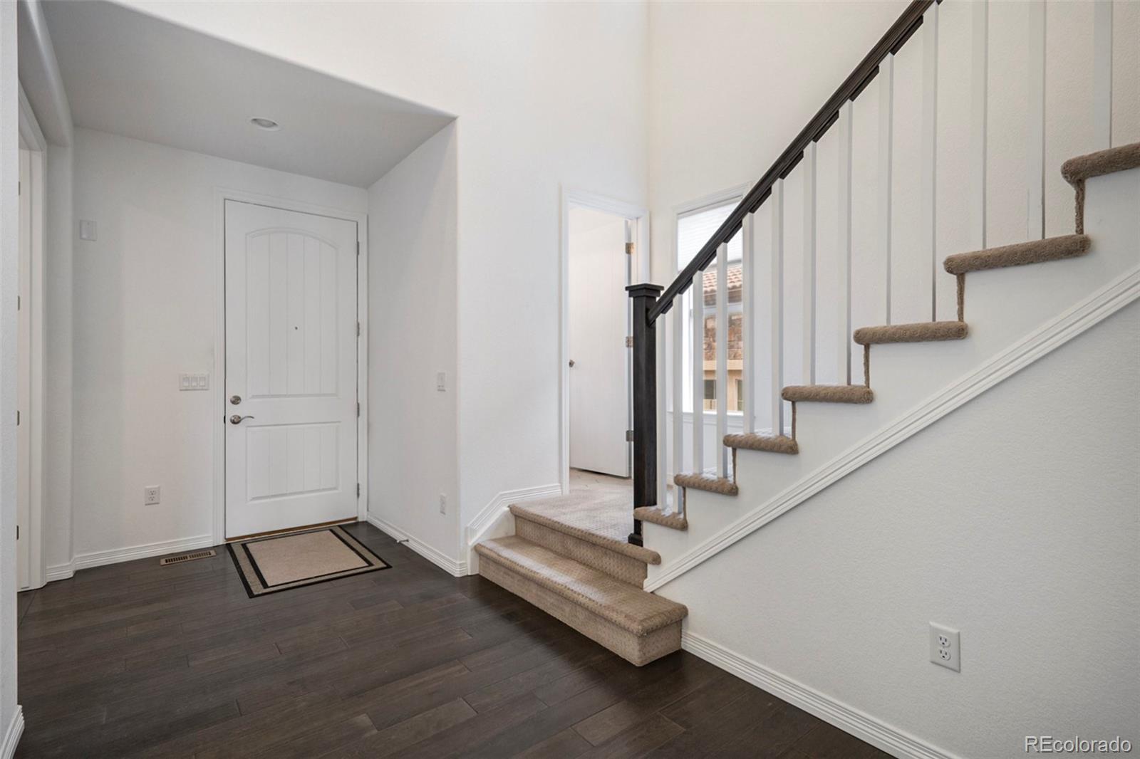 10610 Greycliffe Drive Highlands Ranch, CO 80126 - Photo 17 of 49 a view of entryway and hall with wooden floor