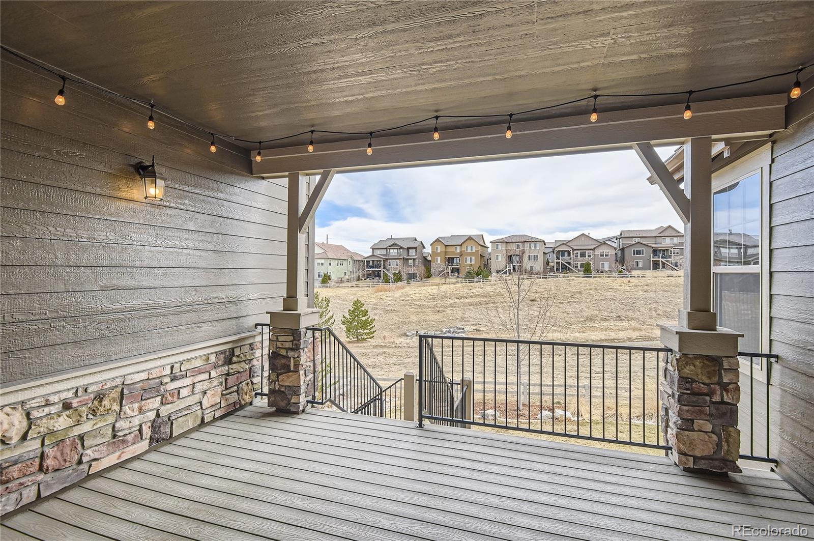 10610 Greycliffe Drive Highlands Ranch, CO 80126 - Photo 19 of 49 a view of a balcony with wooden floor next to a iron stairs