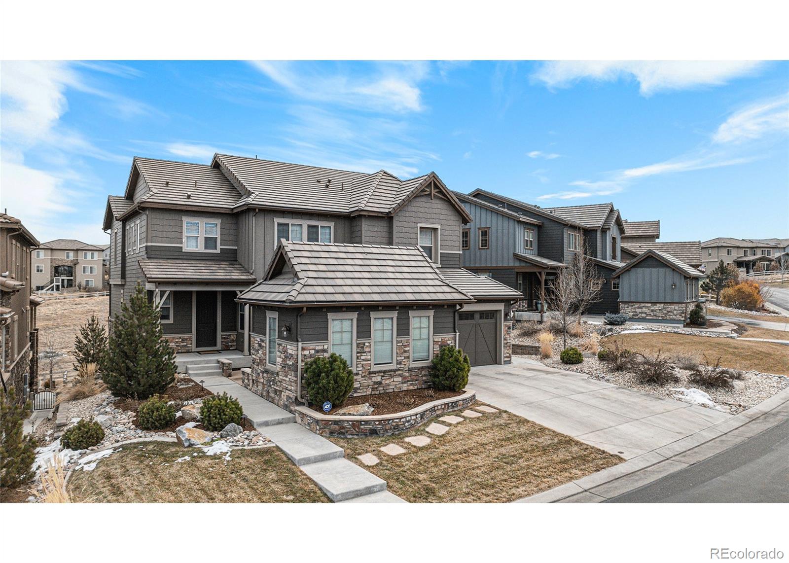 10610 Greycliffe Drive Highlands Ranch, CO 80126 - Photo 4 of 49 a front view of a house with a yard