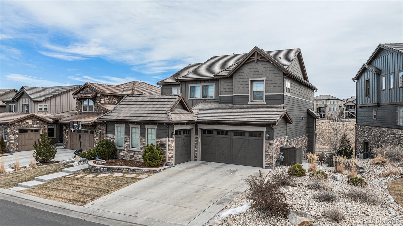 10610 Greycliffe Drive Highlands Ranch, CO 80126 - Photo 45 of 49 a front view of a house with garden