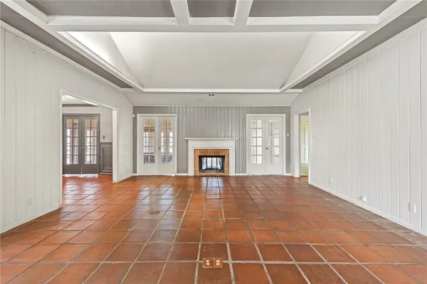 a view of an empty room with a fireplace and a window
