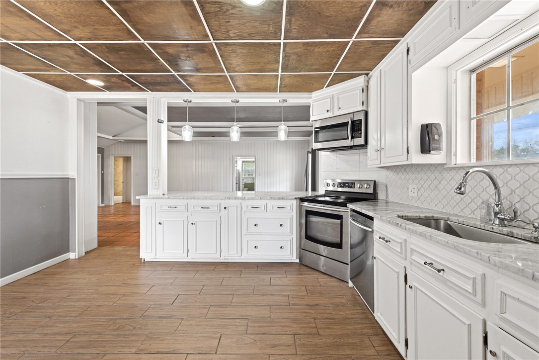 608 Barton Street Calvert, TX 77837 - Photo 6 of 16 a kitchen with stainless steel appliances a stove sink and refrigerator