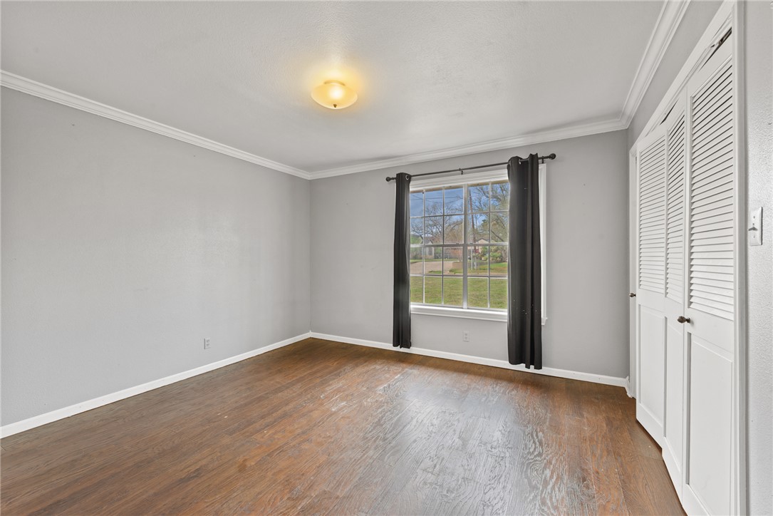 608 Barton Street Calvert, TX 77837 - Photo 8 of 16 a view of an empty room with wooden floor and a window