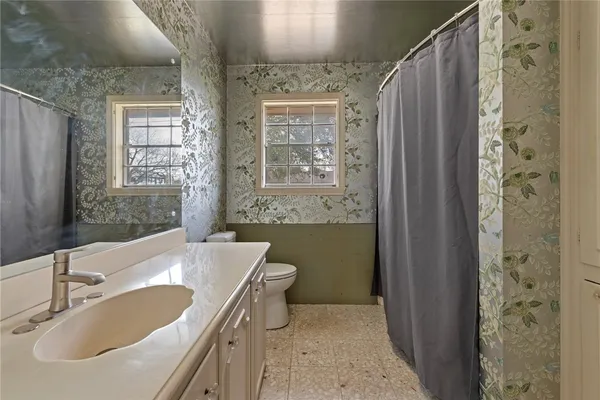 a bathroom with a tub sink and mirror