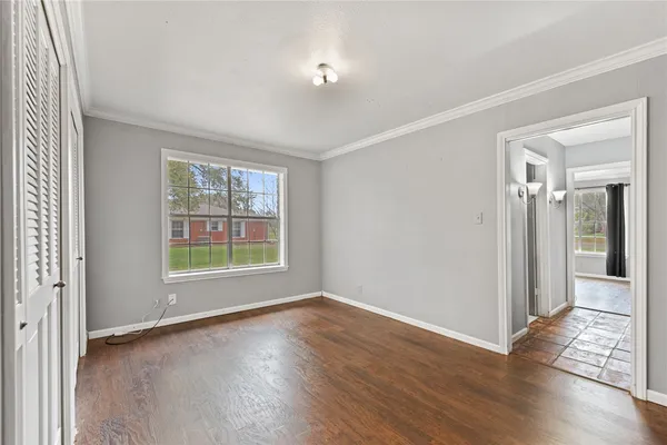 a view of a livingroom with wooden floor and a window