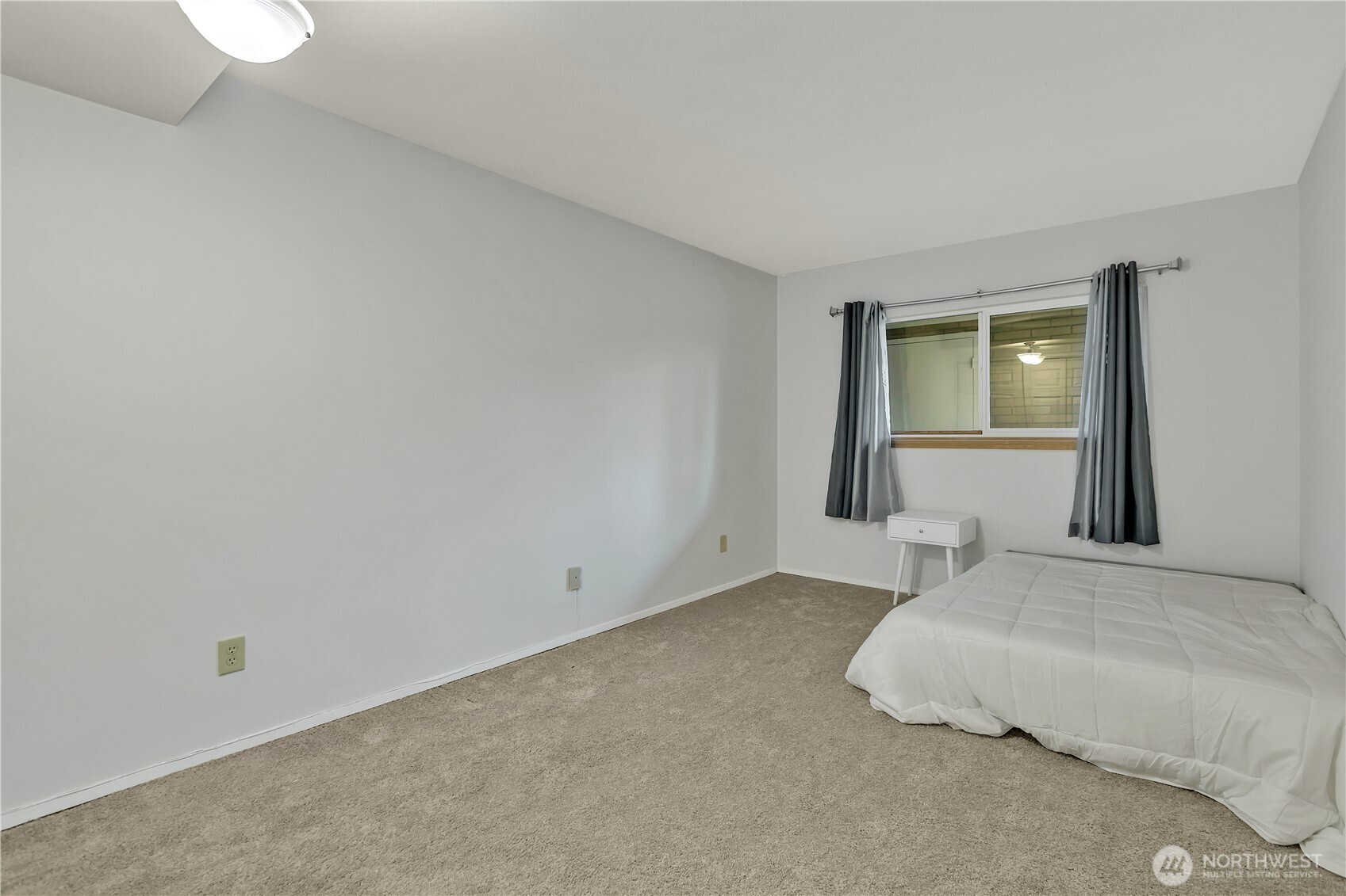 4545 Sand Point Way Northeast, Unit 207 Seattle, WA 98105 - Photo 20 of 25 a bedroom with a bed and a window