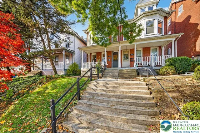 a front view of a house with a yard table and chairs