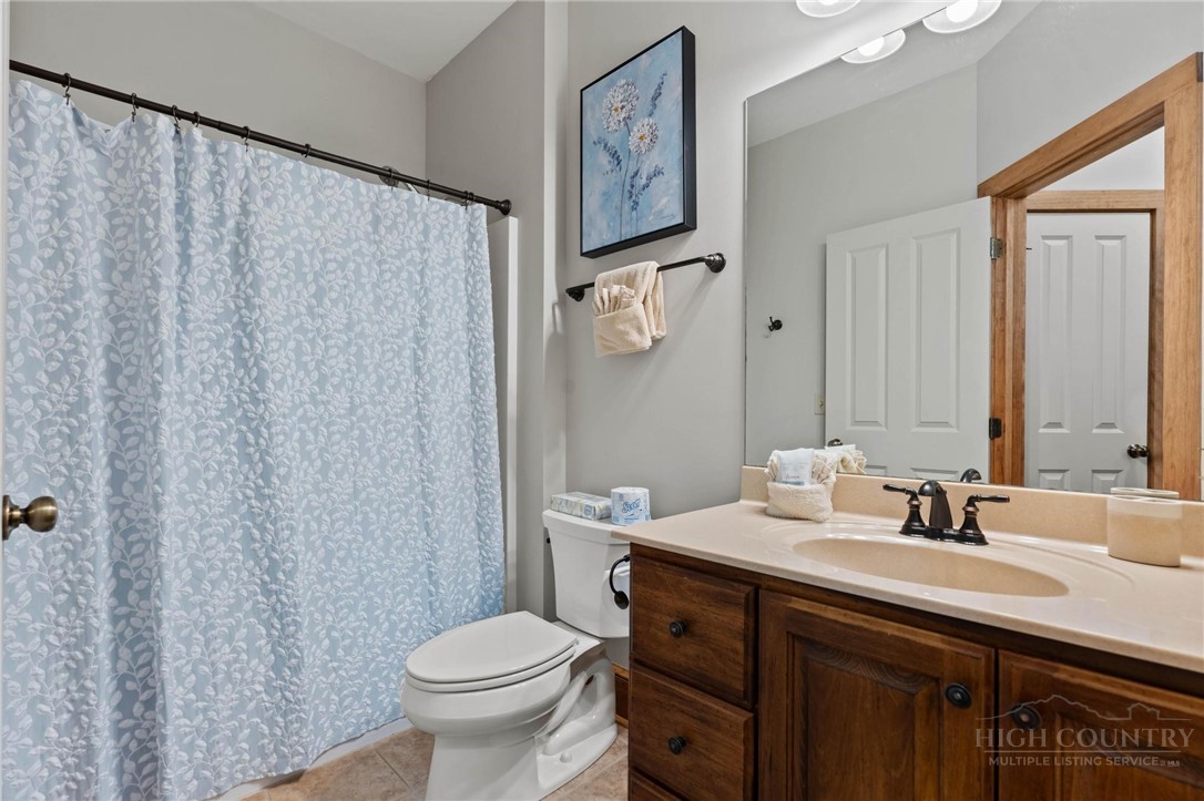 142 Evening View Lane, Unit CA3 Boone, NC 28607 - Photo 22 of 41 a bathroom with a sink a toilet and a mirror