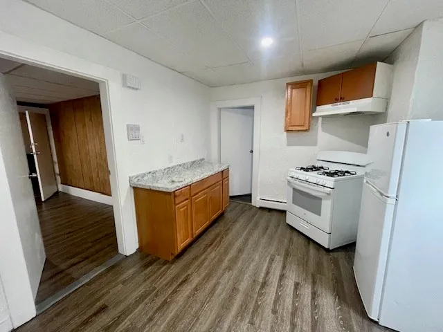 a kitchen with stainless steel appliances a refrigerator and a stove top oven