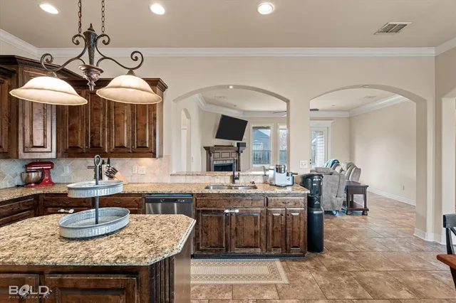 a kitchen with a dining table and chairs