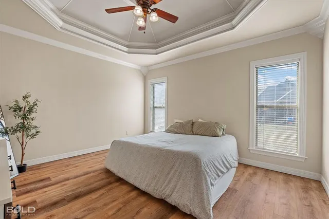 a bedroom with a large bed and a chandelier