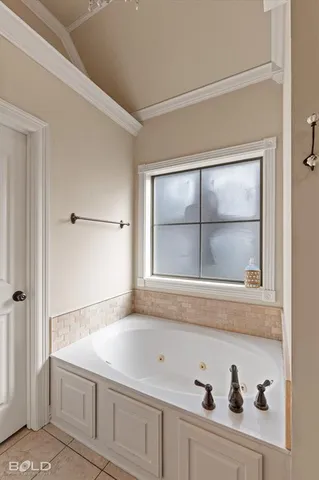 a bathroom with a bathtub and a window