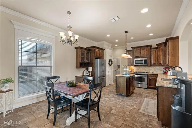 a view of a dining room with furniture and chandelier