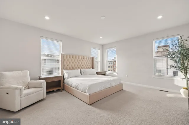 a bedroom with a bed couch and window