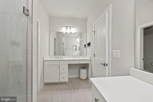 a spacious bathroom with a double vanity sink mirror and shower