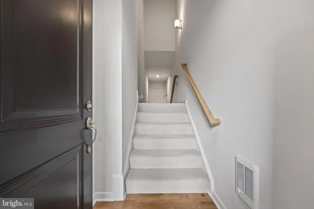 a view of staircase with white walls and window