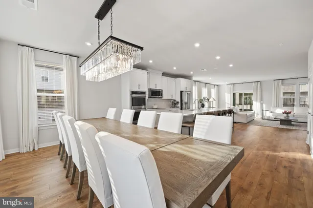 a large kitchen with a table and chairs
