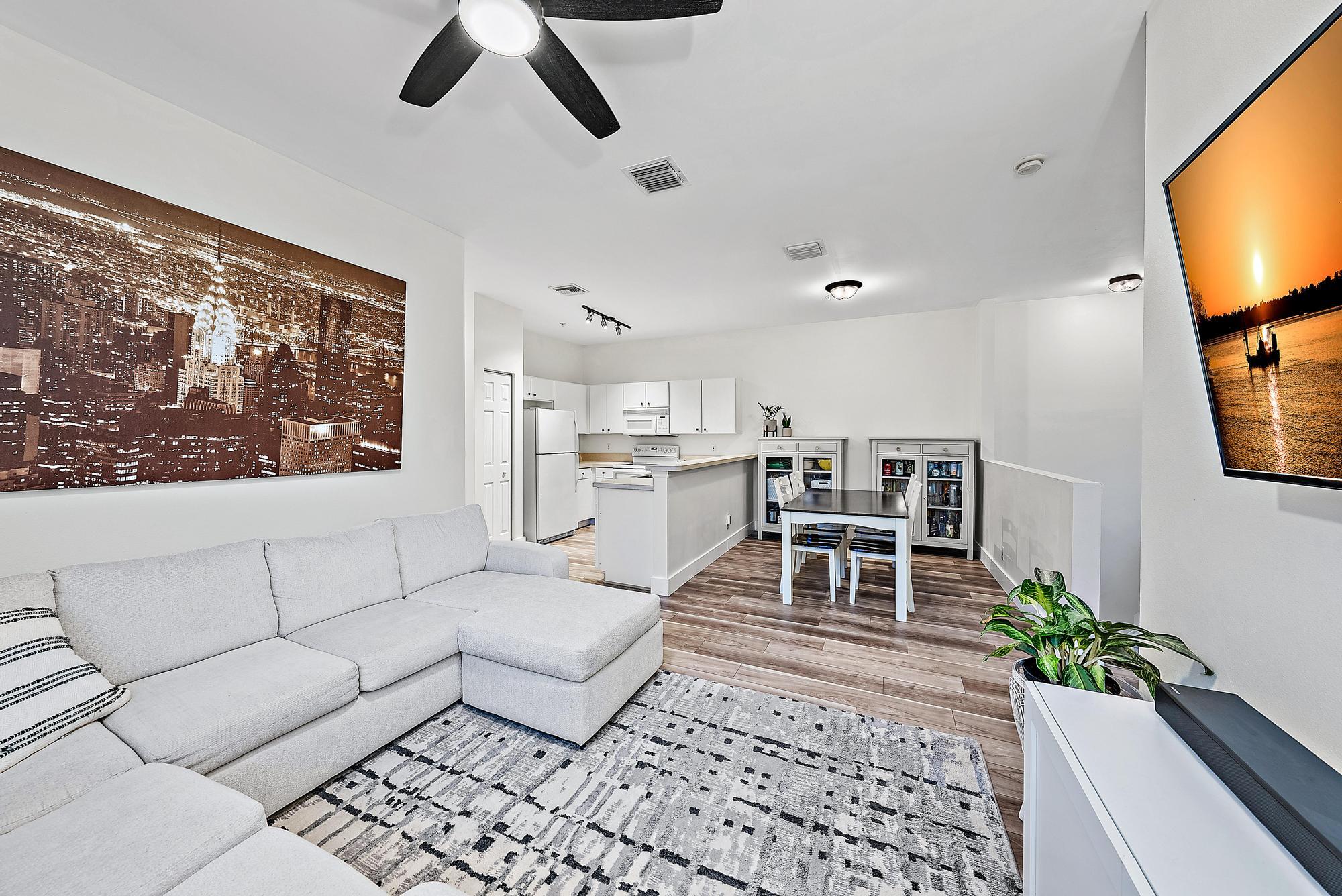 105 Lighthouse Circle, Unit J Tequesta, FL 33469 - Photo 1 of 18 a living room with furniture and a flat screen tv