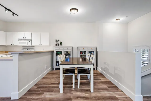 a dining room with furniture and wooden floor