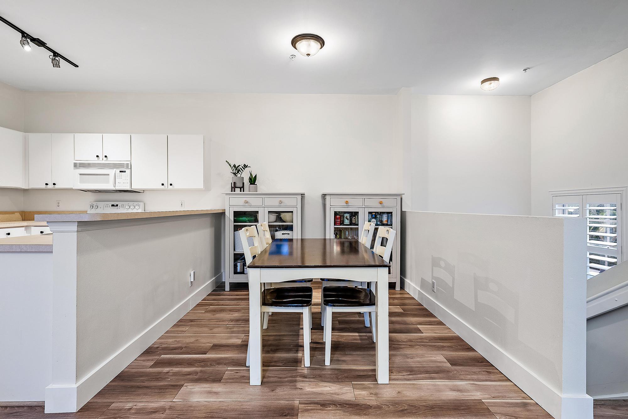 105 Lighthouse Circle, Unit J Tequesta, FL 33469 - Photo 11 of 18 a dining room with furniture and wooden floor