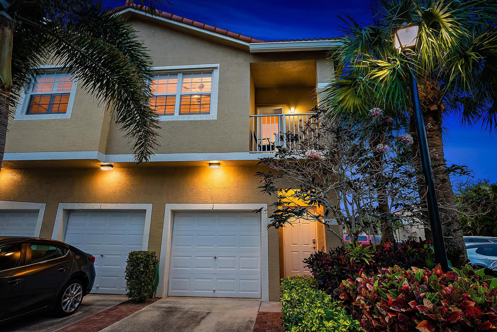 105 Lighthouse Circle, Unit J Tequesta, FL 33469 - Photo 2 of 18 a view of a house with a yard