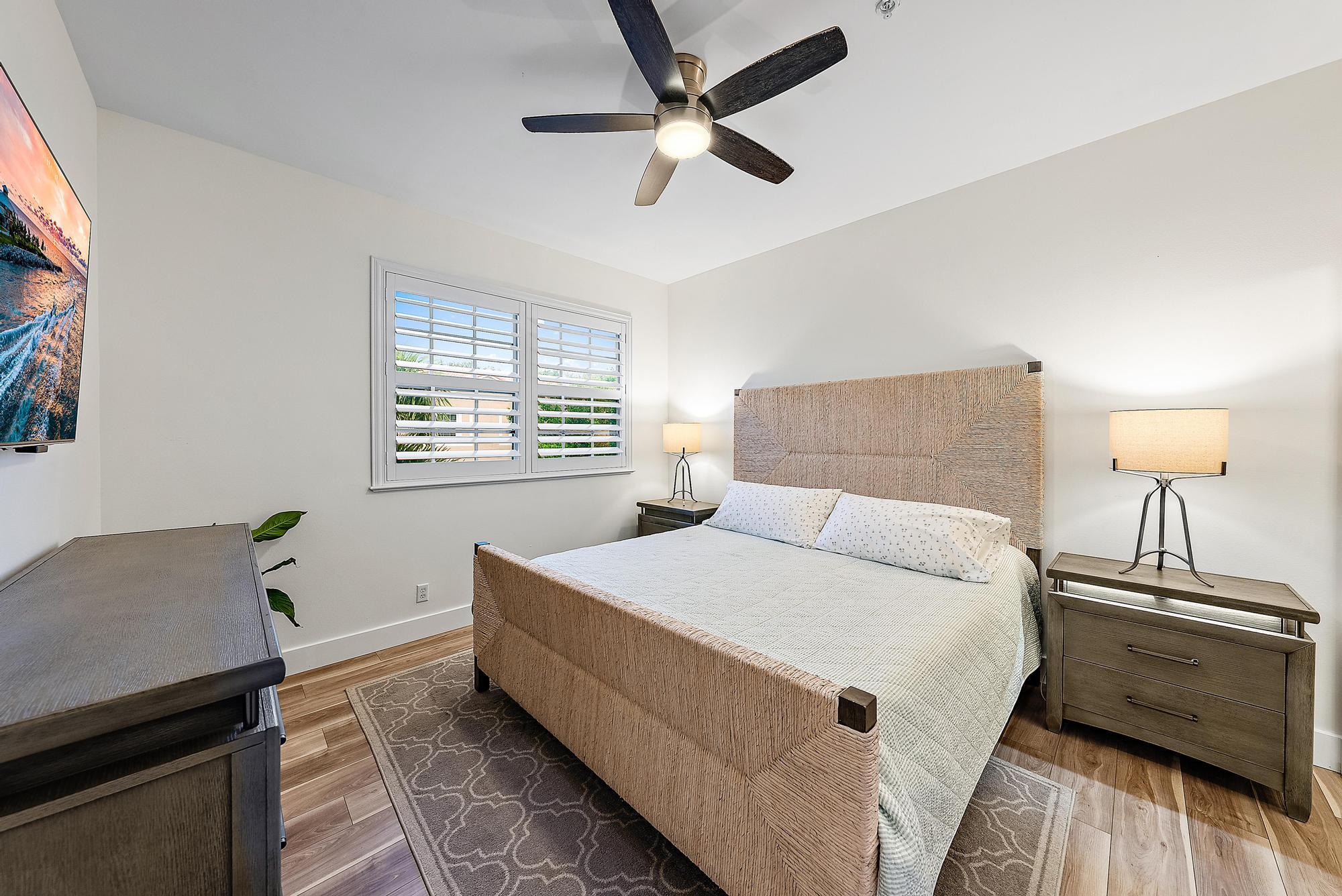 105 Lighthouse Circle, Unit J Tequesta, FL 33469 - Photo 6 of 18 a bed room with a bed and a night stand