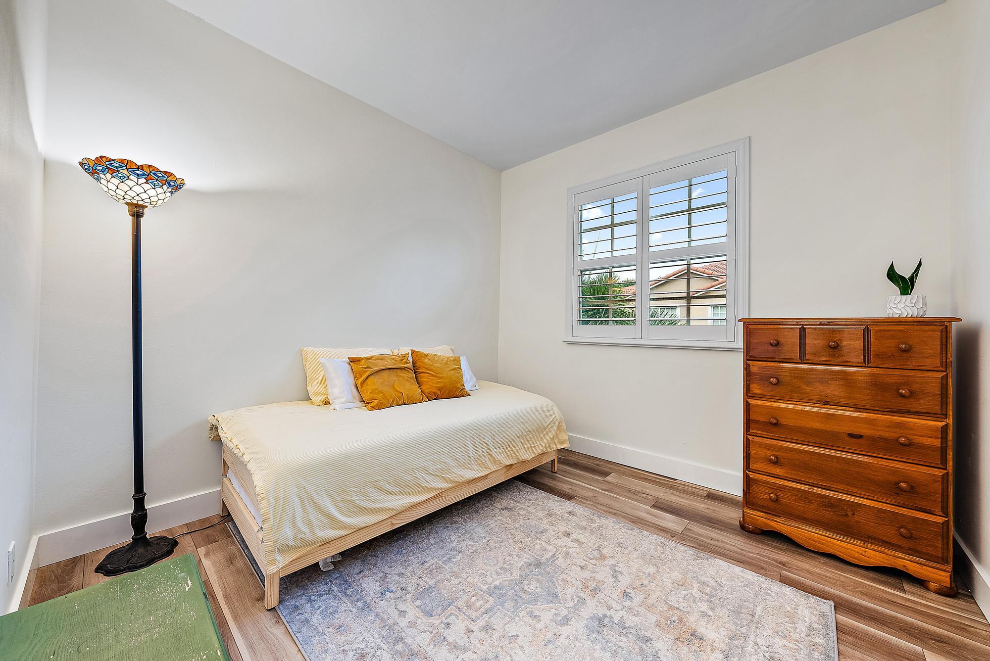 105 Lighthouse Circle, Unit J Tequesta, FL 33469 - Photo 7 of 18 a bedroom with a bed and a window