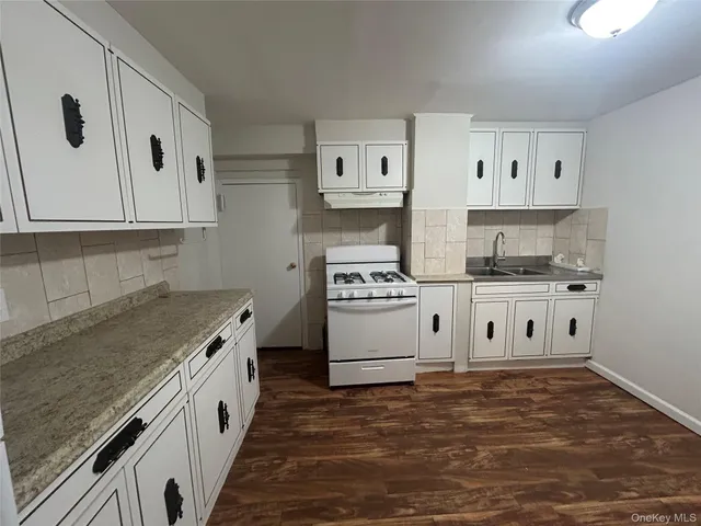 a kitchen with stainless steel appliances granite countertop a stove and a refrigerator