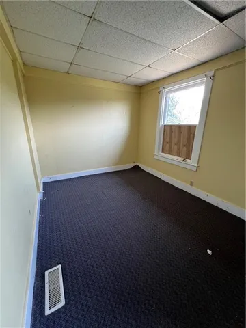 a view of a room that has wooden floor and a window